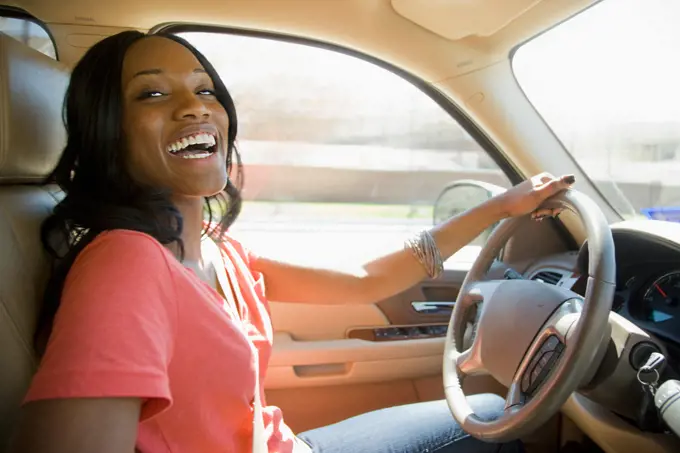 Smiling African American woman driving car