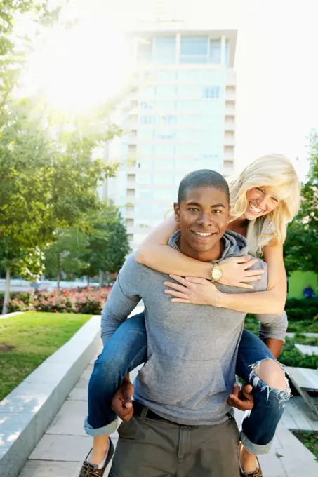 Man giving girlfriend piggyback ride