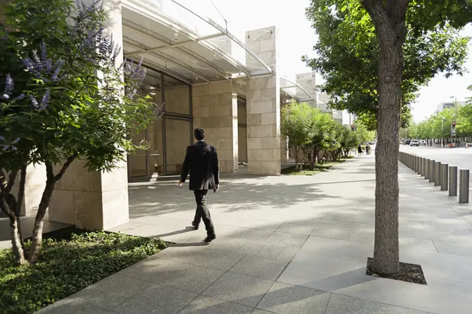 Businessman walking into office building