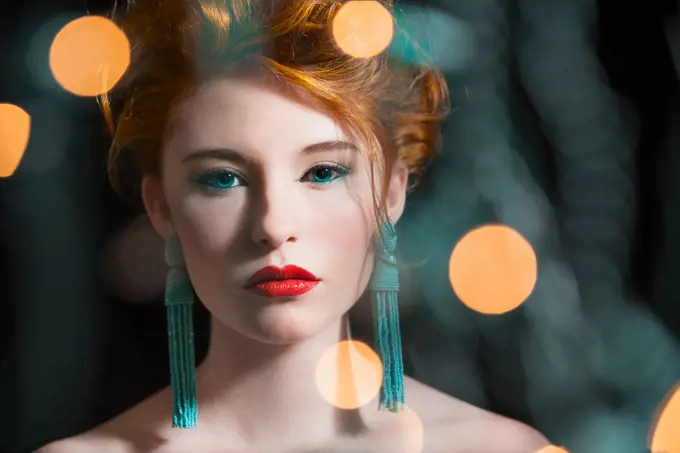 Caucasian woman with glamorous make-up and earrings