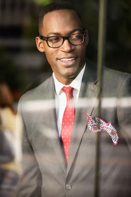 Black businessman looking out office window