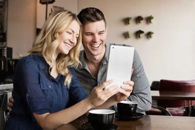 Caucasian couple using digital tablet together