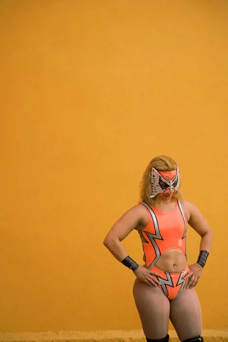 Hispanic woman wearing Mexican wrestling costume