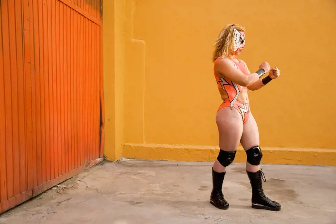 Hispanic woman wearing Mexican wrestling costume