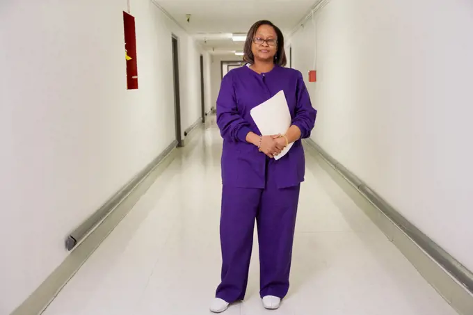 African nurse in hospital corridor