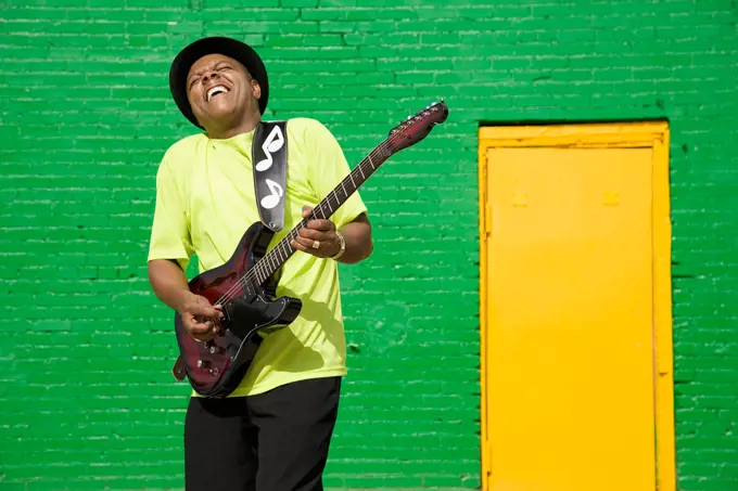 African musician playing electric guitar