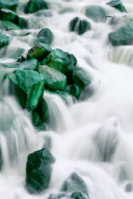 Water rushing over green rocks, Irian Jaya, New Guinea, Indonesia