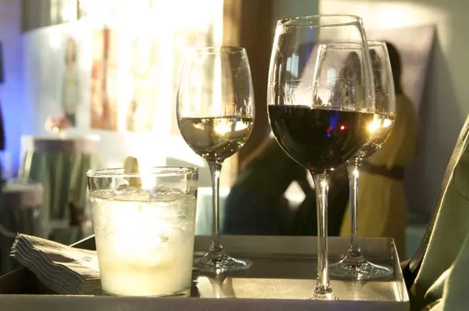 Low angle close up of wine glasses backlit by sunlight