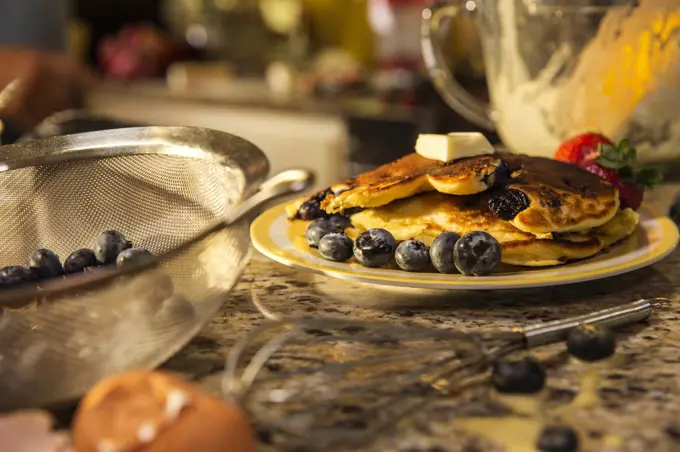 Messy kitchen counter after making blueberry pancakes 