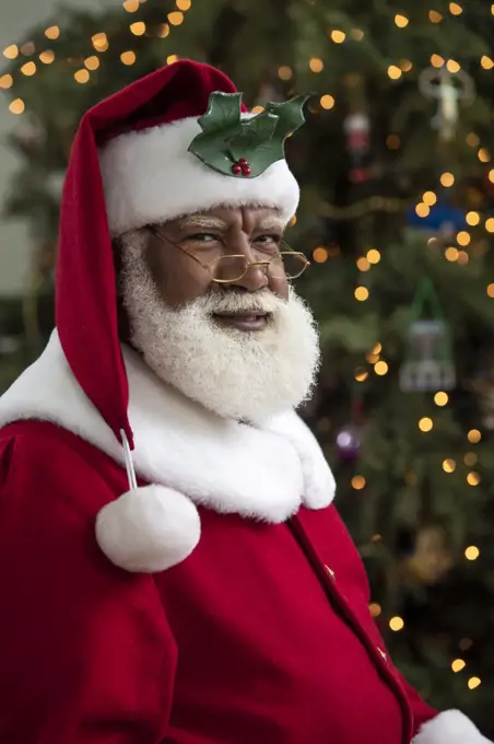 Dark portrait of an African American Black man dressed as Santa Claus