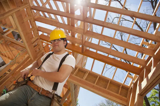 Low angle view of a man working at a residential construction site