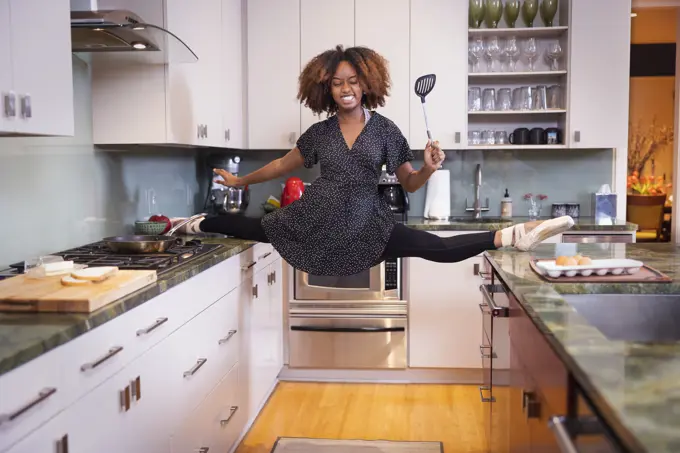 A ballet dancer taking her dancing home with her, cooking breakfast