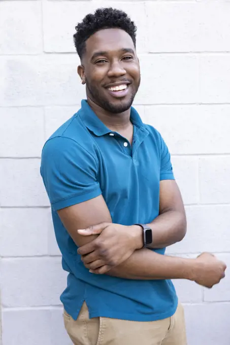 Portrait of a happy young man standing outside looking at camera