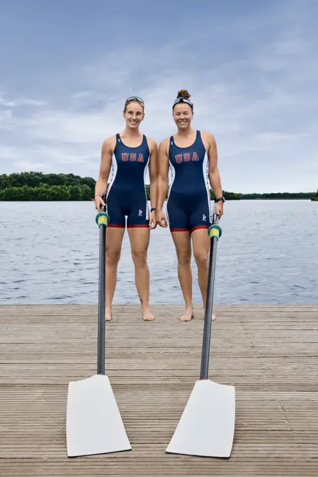 Portrait of USA Olympic rowers, Azja Czajkowski and Jessica Thoennes at the US Women's Rowing training facility in Princeton, NJ holding oars on a dock