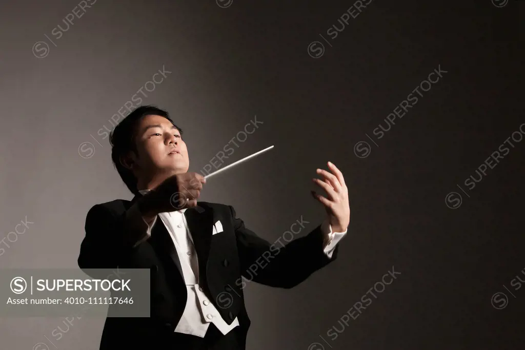 Korean man conducting orchestra