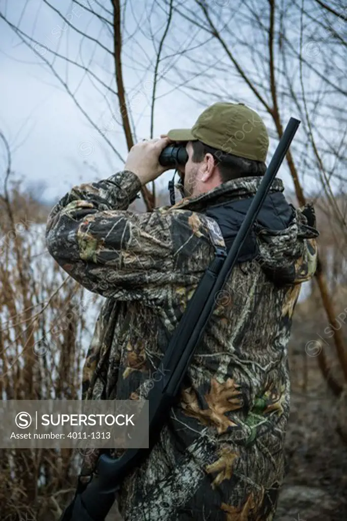 Duck hunter using binoculars