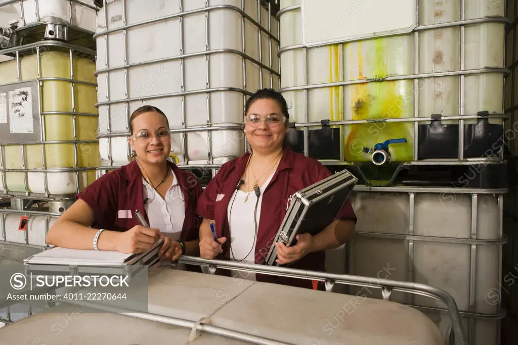 Hispanic women smiling in manufacturing plant