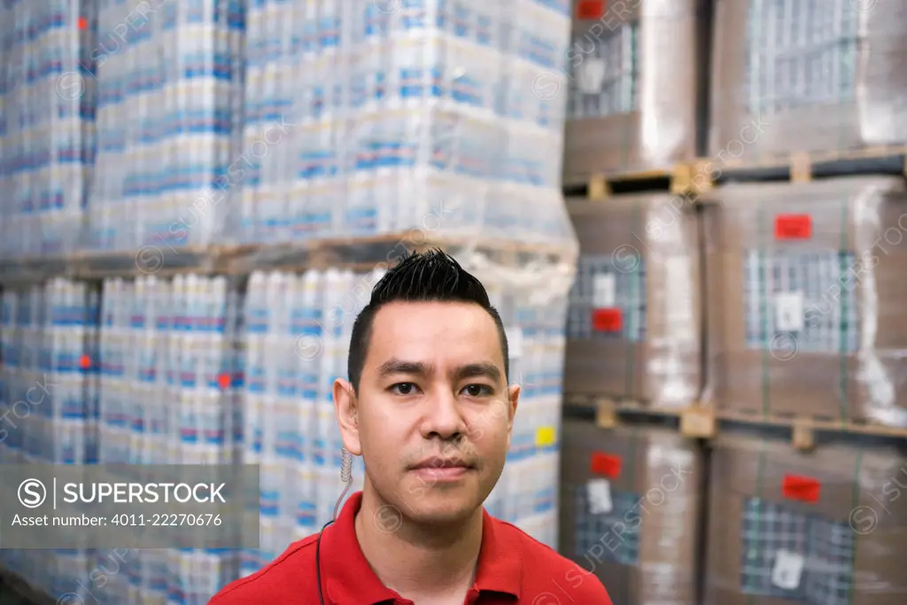 Serious Hispanic man in warehouse