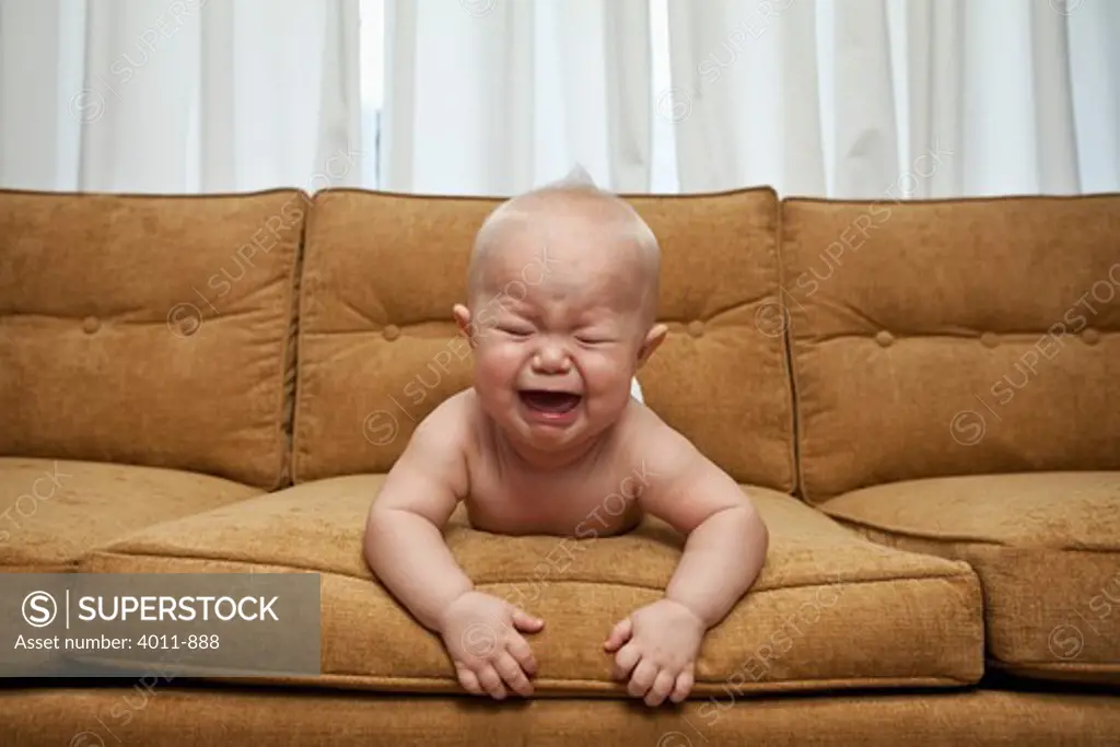 Seven month old baby on couch crying