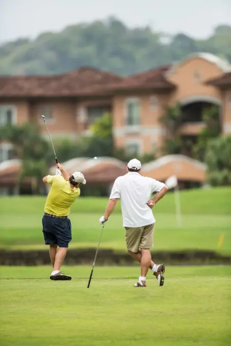 Costa Rica, Two Golfers teeing off over water