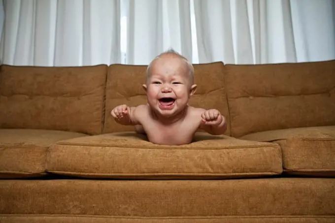 Seven month old baby on couch crying