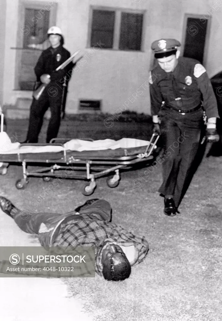 March 1966 Watts Riot. A sniper killed two in Watts section of Los Angeles. Ambulance attendants pick up the body of African American, Joe Crawford, 33, one of two Watts men killed by a sniper at an intersection. March 15, 1966.