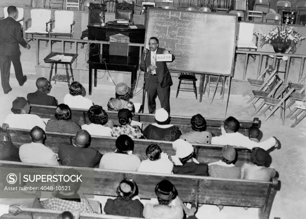 Voter registration drive. In a southern church basement, an African American leads a training session for a voter registration drive. Ca. 1950s.