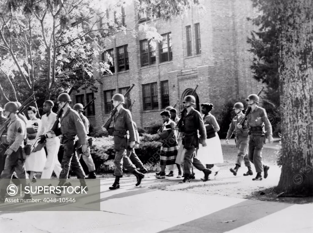 African-American students leaving Central High School under military escort, Little Rock, Arkansas. Sept.- Oct. 1957.