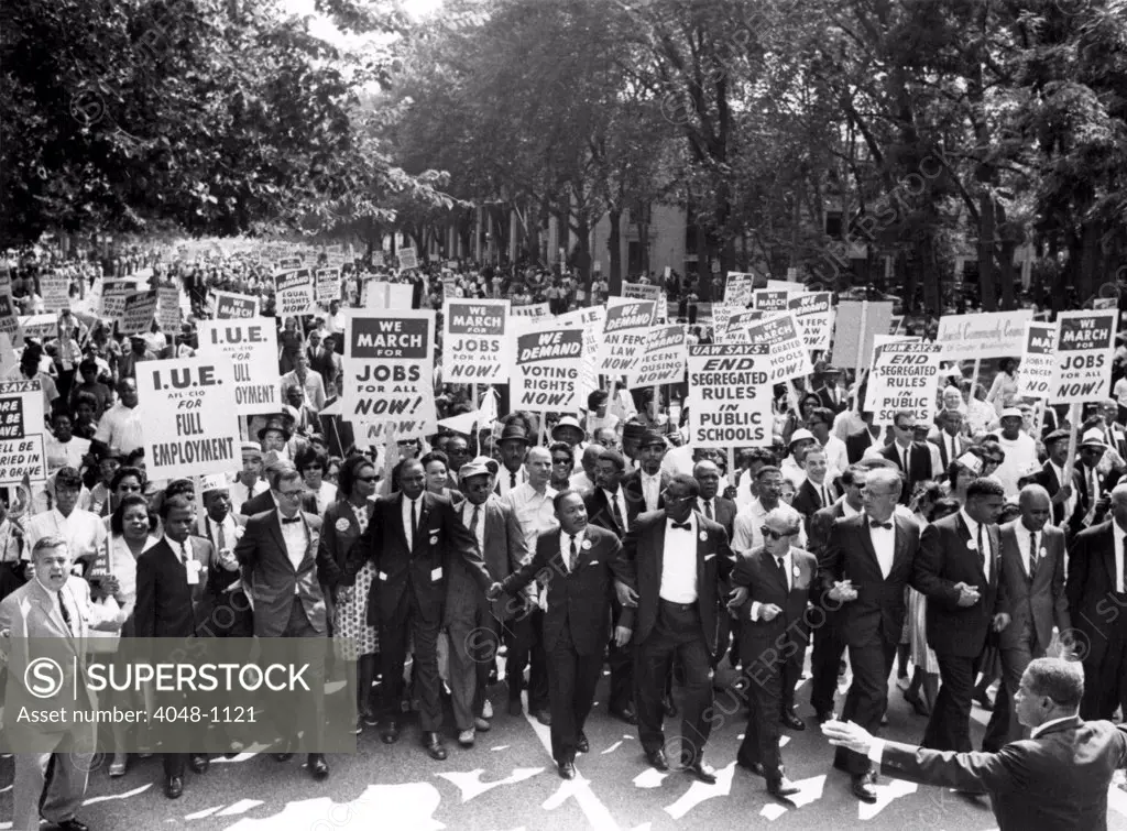 WASHINGTON, DC: Leaders of the March on Washington, lock hands & arms together as they move along Constitution Ave, August 28, 1963. A. Philip Randolph, march director, (R), Roy Wilkins, executive secretary of the NAACP, 2nd from R. The Rev. Martin Luther King, is 7th from L.