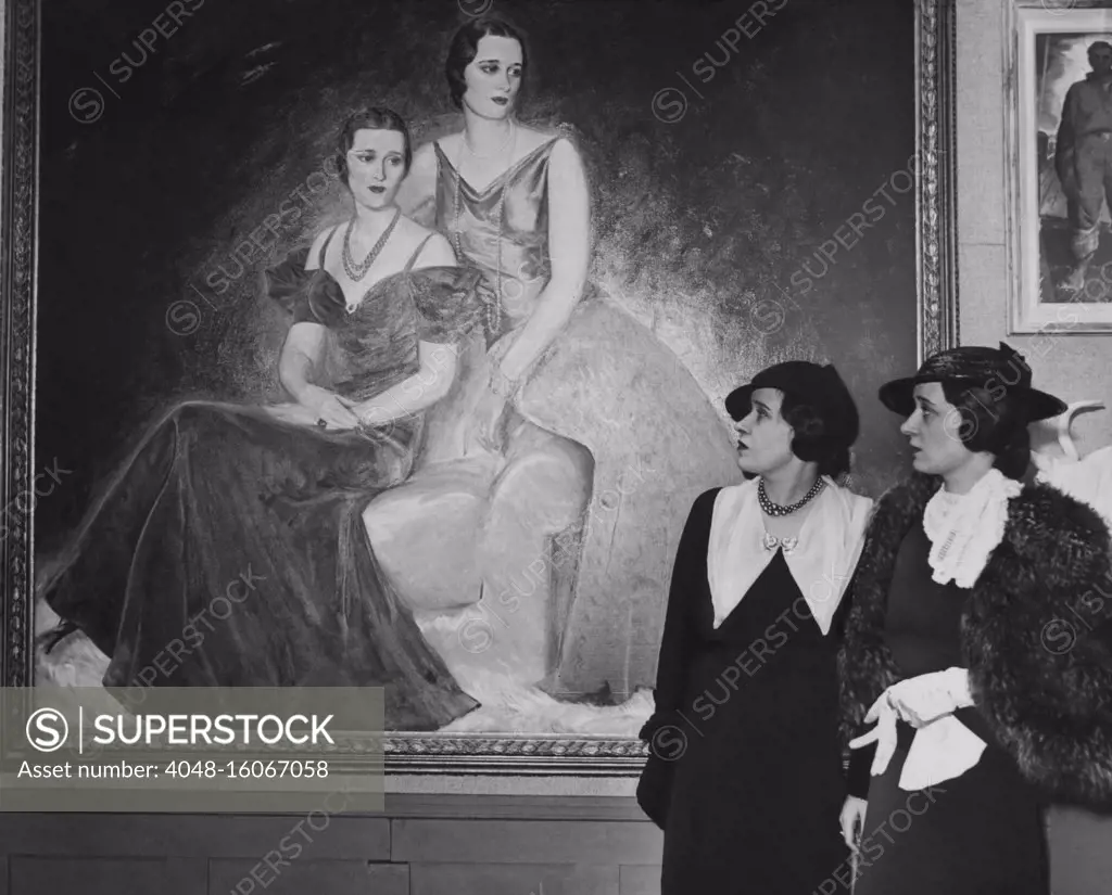 Twin sisters Lady Thelma Morgan Furness (left) and Gloria Morgan Vanderbilt, in Feb. 1835. They look at Paul Trebilcock's portrait of them, painted when they were debutants, known as the 'Magnificent Morgans' in the 1920s  (BSLOC_2020_2_34)