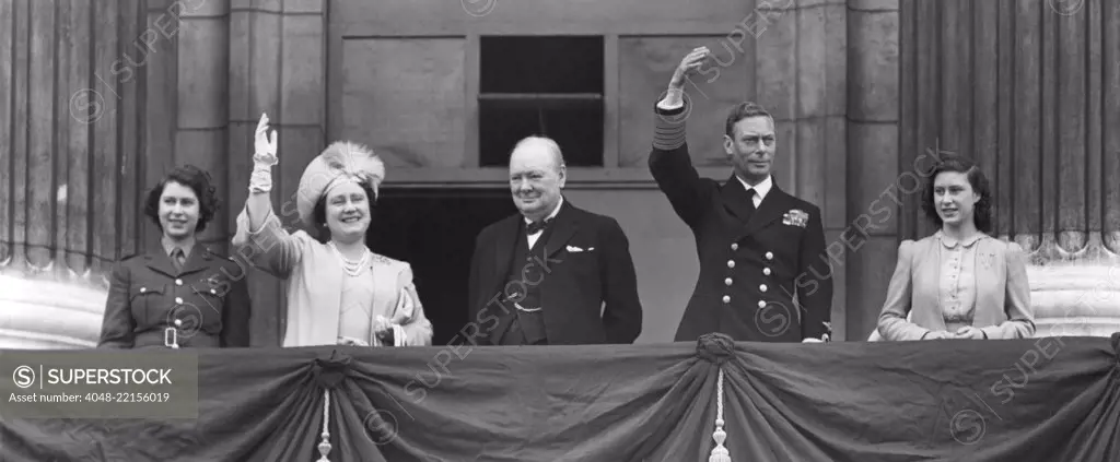 British Royal Family waves to crowds on Victory in Europe Day, May 8, 1945. Prime Minister Winston Churchill takes the central position of honor on the Buckingham Palace balcony. L to R: Princess Elizabeth, wear her ATS Uniform; Queen Elizabeth, Winston Churchill, King George and Princess Margaret. - (BSLOC_2014_14_19)