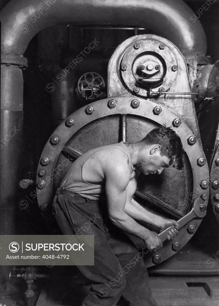 Power house mechanic working on steam pump. Photo by Lewis Hine, 1920.