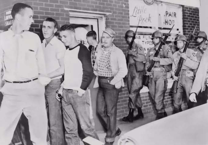 Troops of 101st Airborne Division move a crowd of White young men away from in front of Central High School in Little Rock, Arkansas. Sept.-Oct. 1957.