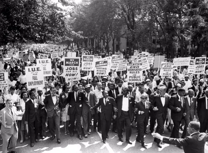 WASHINGTON, DC: Leaders of the March on Washington, lock hands & arms together as they move along Constitution Ave, August 28, 1963. A. Philip Randolph, march director, (R), Roy Wilkins, executive secretary of the NAACP, 2nd from R. The Rev. Martin Luther King, is 7th from L.