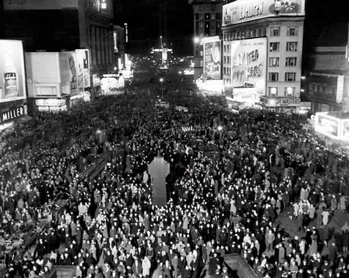 Thousands of people crowd Times Square awaiting the New Year, South from Duffy Square, New York City, December 31, 1945