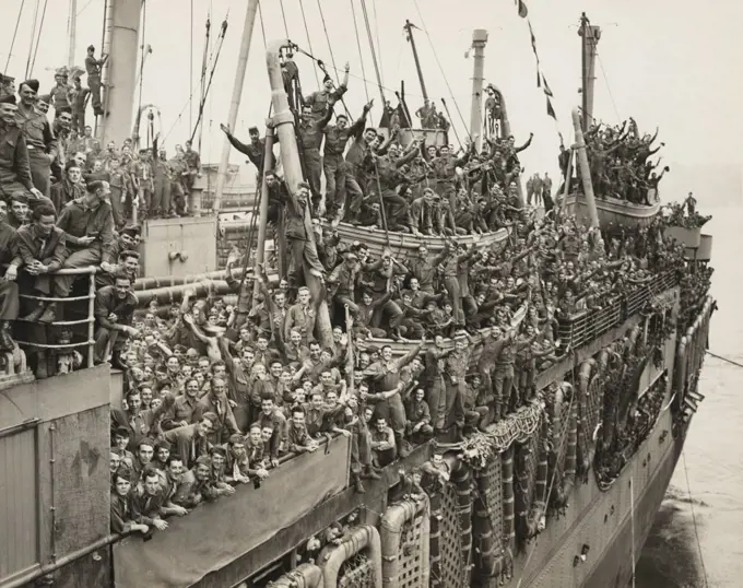 After victory in Europe, the Troops of the 20th Armored Division and units of the 9th Army whoop it up as the SS John Ericsson nears it pier on New York City's Hudson River. August 6, 1945.