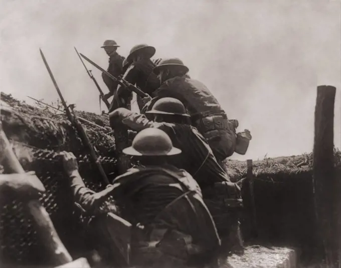 Allied soldiers climb out of the defensive trench to engage in battle on the Western front during World War I. Ca. 1917.