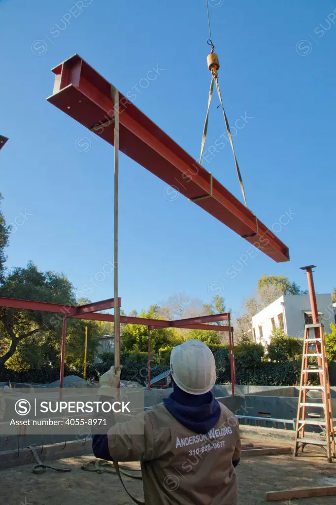 Aligning steel beams. Steel framing began on 1/14/2013 over the foundation on the Begley's new home. Steel, while not a common material for residential framing, is 94% recyclable, has been milled locally for this project, and is a more sustainable choice than wood, which is typically used for residential building construction. Studio City, California, USA