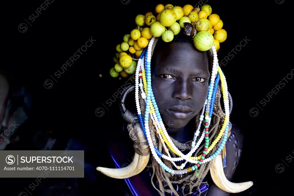 Young girl wearing traditional headdress. Mursi tribe, Mago National Park. Omo Valley, Ethiopia.