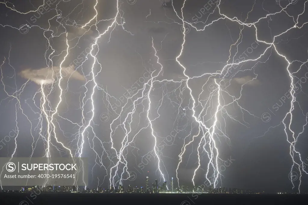 Lightning strikes above skyscrapers on Gold Coast coastline, composite image of strikes over a twenty minute period. Queensland, Australia. 2018.