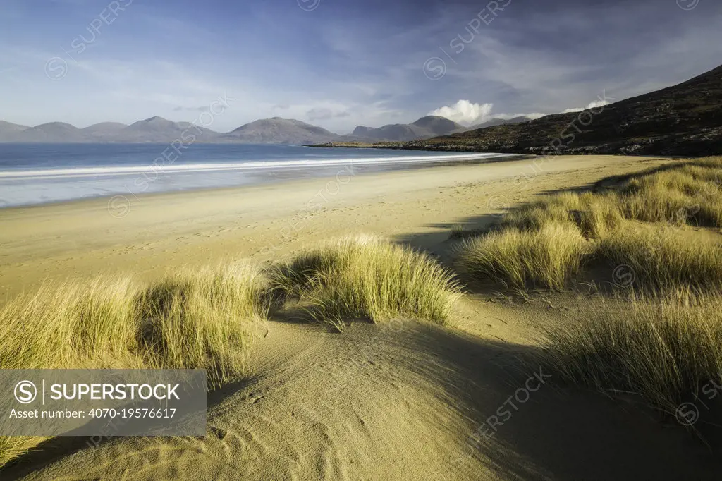 Sand dunes at Luskentyre, mountains across sea. Isle of Harris, Outer Hebrides, Scotland, UK. March 2014.