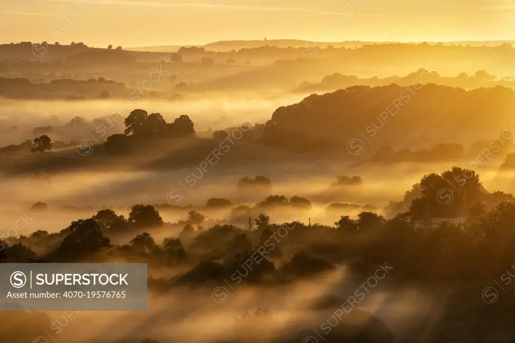 Sunrise over the Blackmore Vale from Cadbury Castle, South Cadbury, Somerset, England, UK, May 2020.