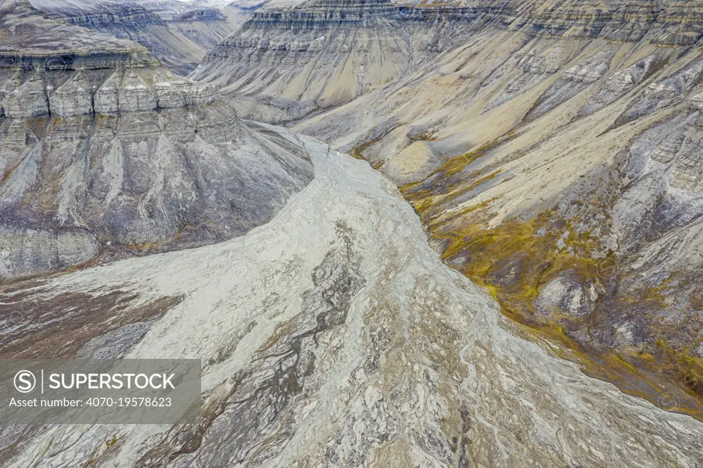 Aerial view of eroded mountain slopes and rich network of river channels. Skansdalen, Spitsbergen, Svalbard, Norway