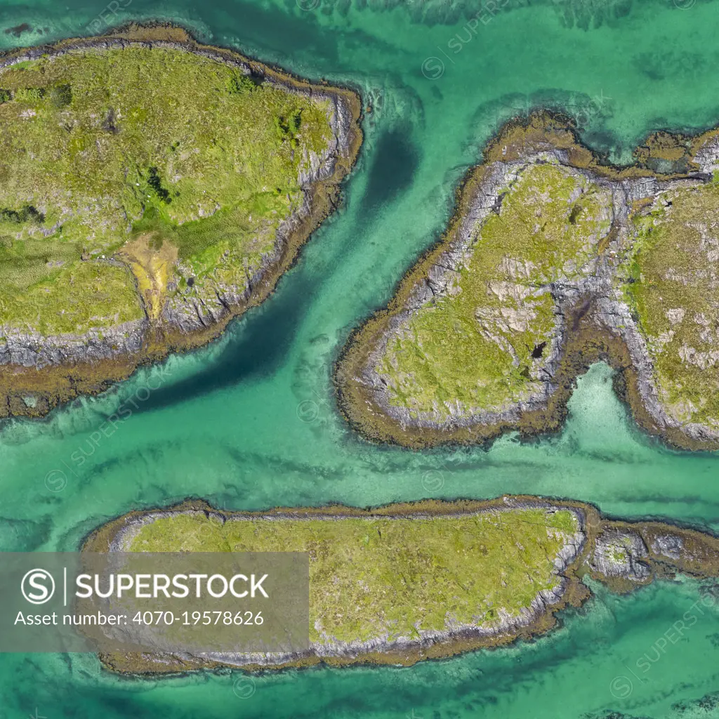 Aerial view of sporadically inhabited islands, Islets and skerries in a wide coastal plain. Husvaer, Helgeland Archipelago, Norway. July.