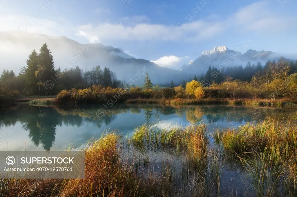 Sava Spring in autumn with reflections in lake, Julian Alps, Kranska Gora, Slovenia, October 2009