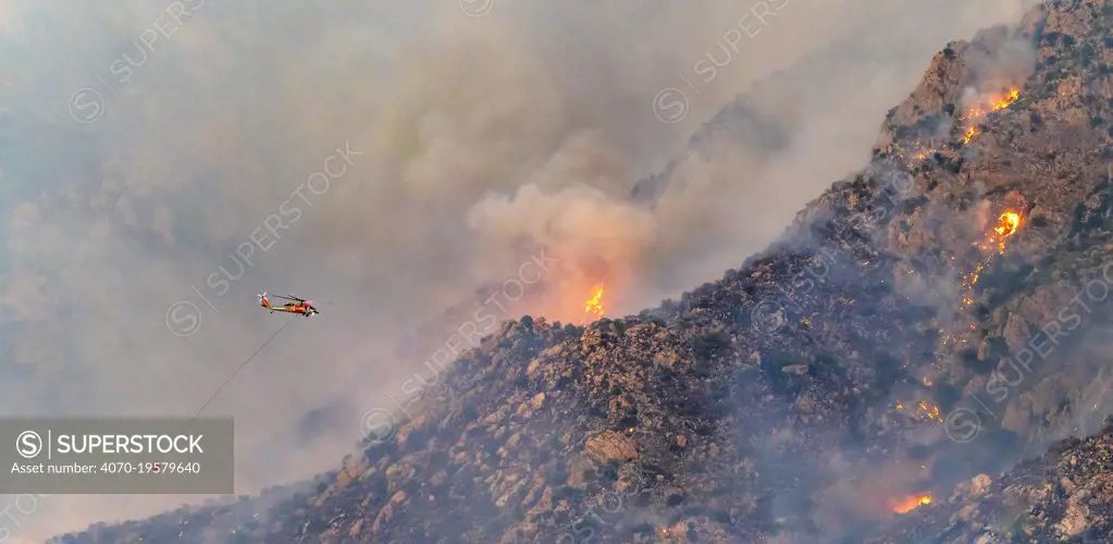 Lightning caused fire on Mount Lemmon, Forest Service Fire suppression Wildland Firefighters use helicopters to 'bomb' the hot spots to control the spread. Mount Lemmon's north palisades, Coronado National Forest, Arizona, USA. 12th June 2020.