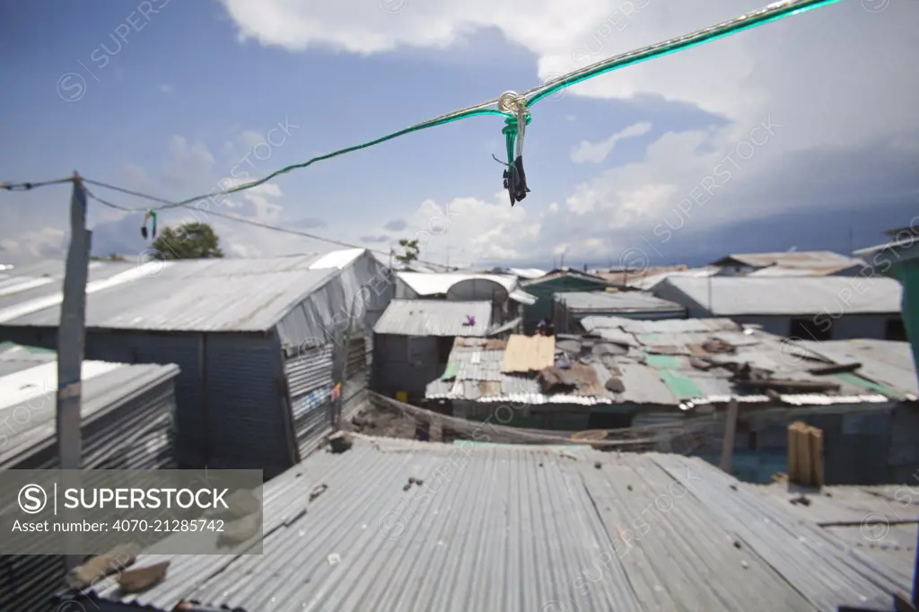 Basic electric wiring linking homes in a slum with a diesel powered generator, Remba Island, Lake Victoria, Kenya.