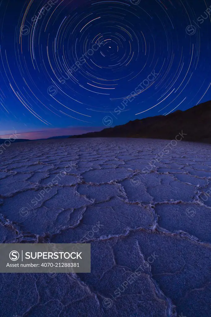 Star trail over Badwater Salt Flats, Death Valley National Park, California. August 2008. Taken with multiple long exposures and fish eye lens.