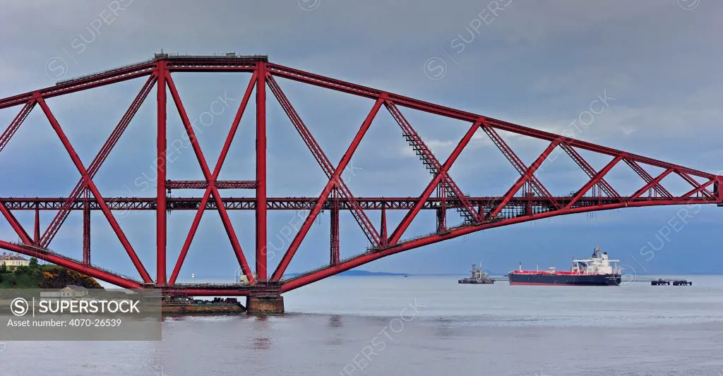 Oil tanker sailing under the Forth Railway Bridge / Forth Rail Bridge, Firth of Forth, near Edinburgh, Scotland, UK, June 2010