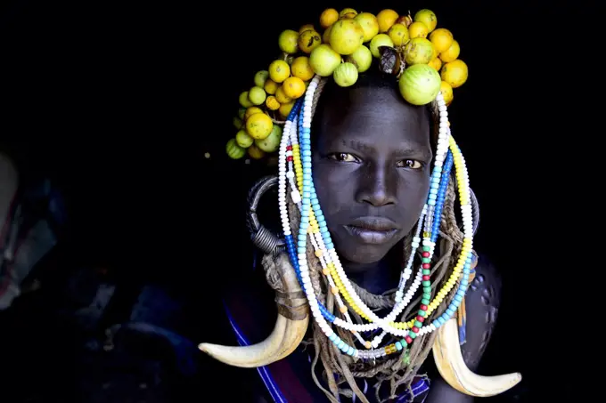 Young girl wearing traditional headdress. Mursi tribe, Mago National Park. Omo Valley, Ethiopia.